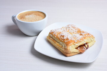 Arequipe puff pastry displayed on white wooden background