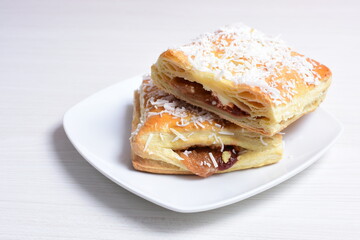 Arequipe puff pastry displayed on white wooden background