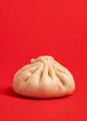 Bao dumpling minimalist isolated on a red background.