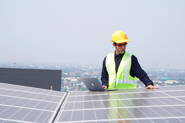 Asian engineer for solar panel inspection roof construction. Engineer worker installing solar panels outdoors