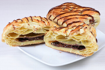 Chocolate puff pastry displayed on white wooden background
