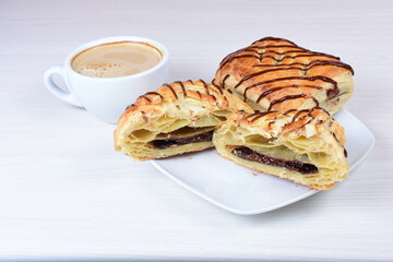 Chocolate puff pastry displayed on white wooden background