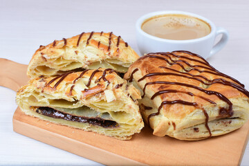 Chocolate puff pastry displayed on white wooden background