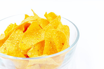Close up Corn chips into a glass bowl, nachos isolated on white background