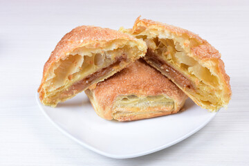 Arequipe puff pastry displayed on white wooden background