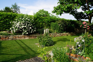 Residential Garden, private garden. Landscape design in home garden, beautiful landscaping in...