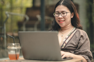 Happy of asian freelance people business female casual working with laptop computer with coffee cup and smartphone in coffee shop like the background,communication concept