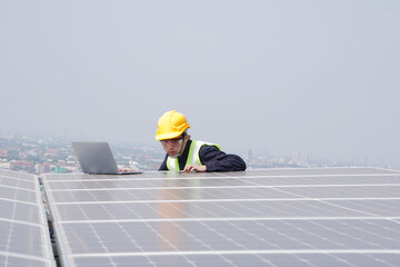 Asian engineer for solar panel inspection roof construction. Engineer worker installing solar panels outdoors