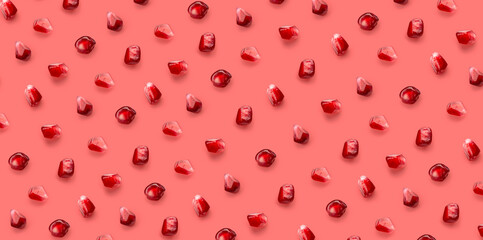 Fresh pomegrante seed pattern on pink background, from above
