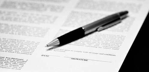 Contract wtih Pen on Desk Business Transaction