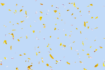 Golden silver sparkling confetti isolated on blue. Holiday effect