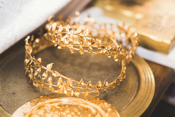 Golden crowns lying on the table in church © olegparylyak