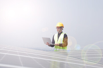 Asian engineer for solar panel inspection roof construction. Engineer worker installing solar panels outdoors