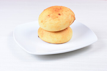 cheese almojabana, on white wooden backgroun