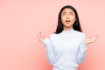 Fototapeta premium Teenager Chinese woman isolated on pink background stressed overwhelmed