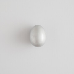 Silver easter egg on a gray background. Minimal holiday concept. Flat lay, top view.