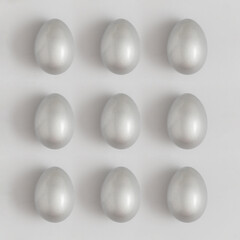 Pattern made of silver easter egg on a gray background. Minimal holiday concept. Flat lay, top view.