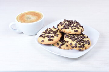 Chocolate chips cookies, on white wooden background