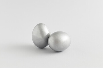 Silver easter egg composition on a gray background. Minimal holiday concept. Flat lay, top view.