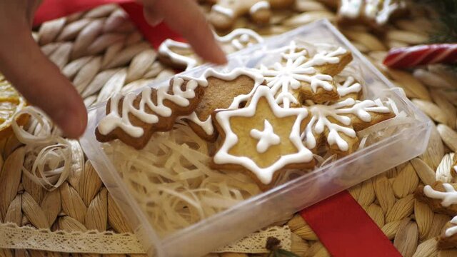 Female hands fold Christmas cookies into a beautiful box 4K