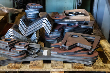 Laser cut iron parts in factory warehouse