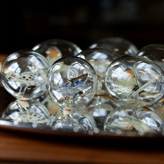 set of glass Easter eggs with a butterfly inside on a silver background.