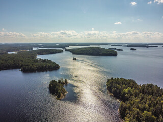 Aerial view of lake Saimaa in sunny summerday. Sun reflecting on lake surface.