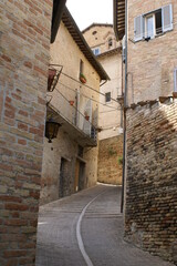 Fototapeta premium A typical narrow alley in the historical centre of Urbino, Marche (Italy)