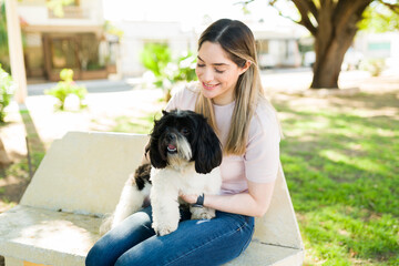 Beautiful dog owner giving love to her cute pet