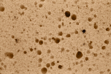 The texture of a dish washing sponge. A porous surface.