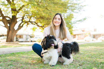 Portrait of a beautiful dog owner with her pet at the park