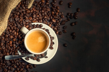 White cup of coffee and coffee bean on dark background. Copy space.view from above.