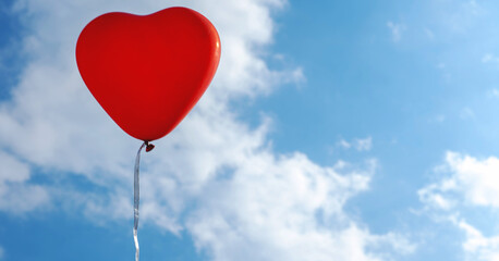 Naklejka na ściany i meble red heart-shaped balloon on blue sky background with clouds