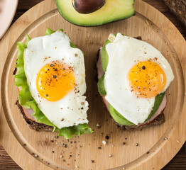 sandwiches with amulets on a wooden board