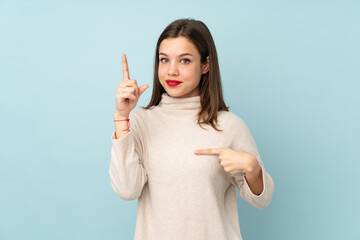 Teenager girl isolated on blue background with surprise facial expression