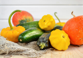 Vegetables for the children's menu. Pumpkin, squash and zucchini as background. 
