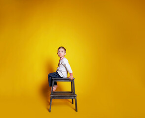 child in jeans and a white sweater