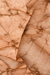 Abstract macro shot of an old color creased paper sheet texture