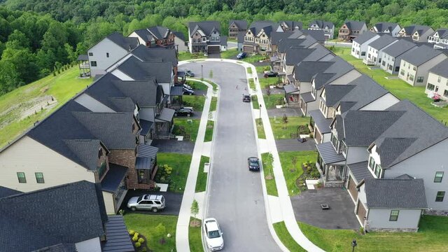 Aerial flyover video in a new neighborhood real estate development cul de sac street in Maryland USA