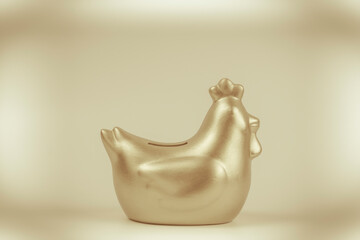 Golden chicken bank isolated on gold background ,saving money concept