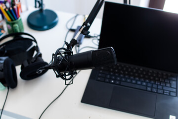Microphone, laptop and headphone for home live streaming session. Tools for digital audience...