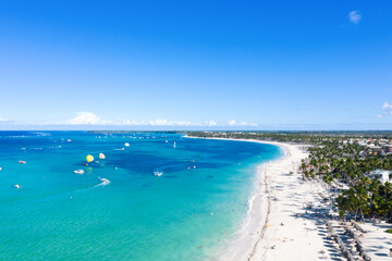 Aerial view from drone on tropical shore with coconut palm trees and turquoise caribbean sea