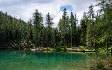 a green lake in the high mountains
