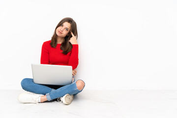 Tenaager girl working with pc isolated on white background making the gesture of madness putting...