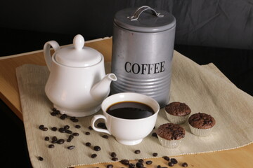 Coffee cup with cupcake on table