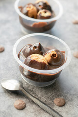 Profiteroles served in tubs with chocolate sauce