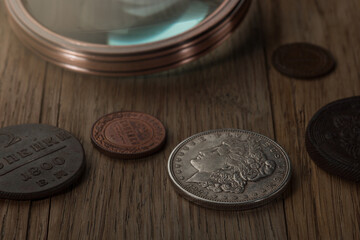 Numismatics. Old collectible coins  on a wooden table.