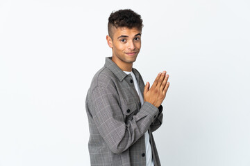 Young brazilian man isolated on white background scheming something