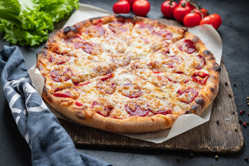 pizza pepperoni sausage tomato sauce and cheese trend fast food meal copy space food background rustic. top view
