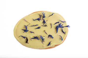 Egg shaped biscuit cookie with white chocolate and dried blue rye flowers